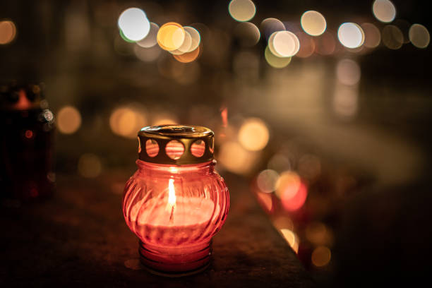 istock Jars with burning candles on stone surface at night 1182902566