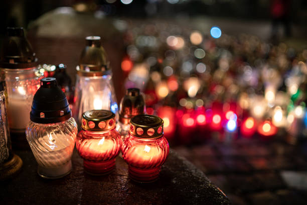 istock Jars with burning candles on stone surface at night 1182902643