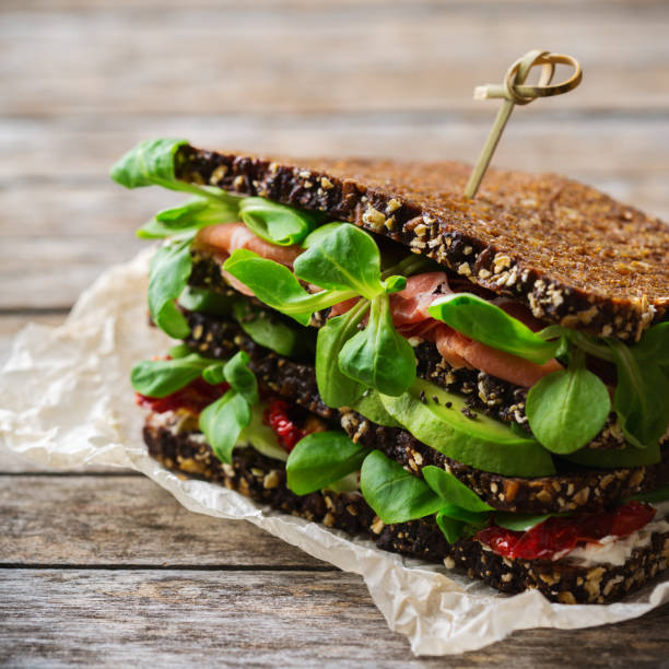 istock Rye bread sandwich with ham, lettuce and dried tomato 1182902660