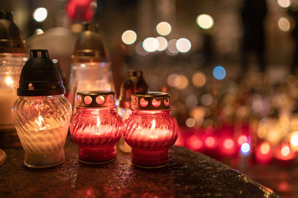 istock Jars with burning candles on stone surface at night 1182902884