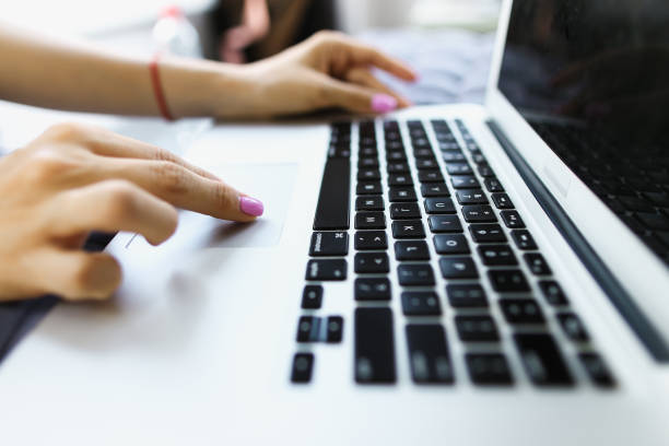 istock Closeup hands with piunk nails typing on laptop keyboard 1182904491