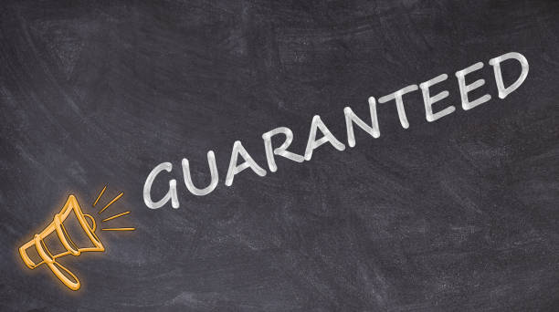 istock Guaranteed on blackboard with megaphone 1182906415