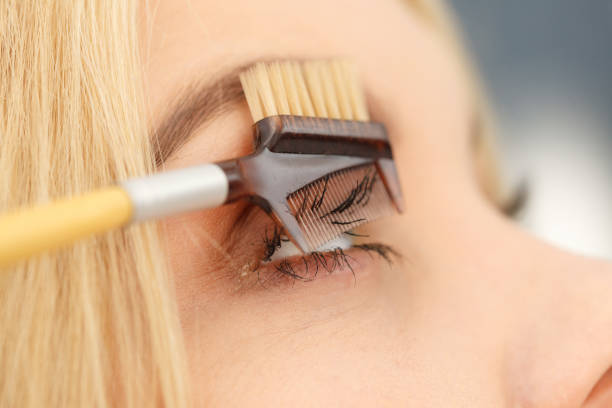 istock Woman brushing her eyelashes 1182907987