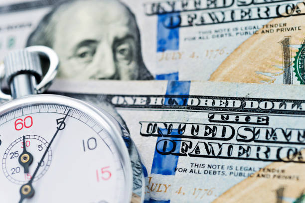 istock Stopwatch on the US dollars 1182908273