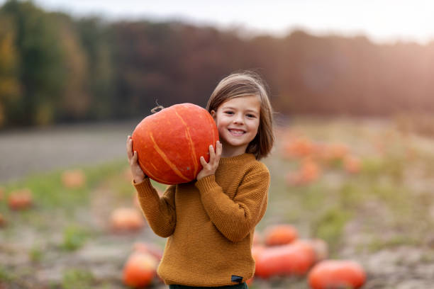 istock Cute little boy having fun in a pumpkin patch 1182909611
