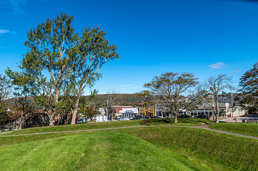 Annapolis Royal, Canada. October 3, 2019: Street of Annapolis Royal from grassy mounds, shops and cars parked.
