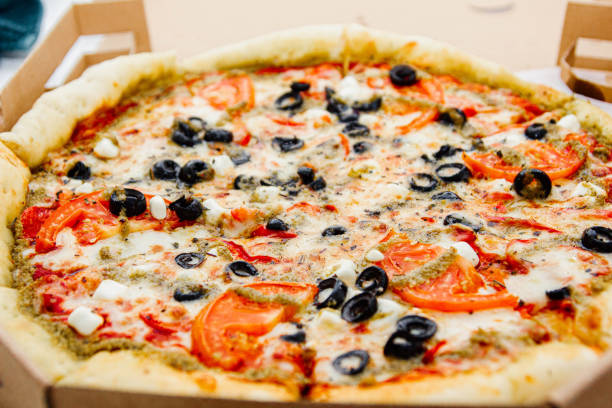 istock vegetarian pizza with olives, tomatoes and cheese. 1182909895
