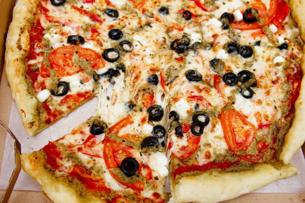 istock vegetarian pizza with olives, tomatoes and cheese. 1182909915