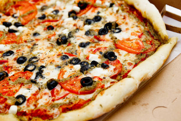 istock vegetarian pizza with olives, tomatoes and cheese. 1182909950