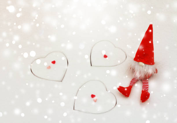 Merry Christmas & Happy New Year greeting card with copy space. Little Santa Claus and heart shapes on the white snow background. Merry Christmas & Happy New Year greeting card with copy space. Little Santa Claus and heart shapes on the white snow background. korean doll stock pictures, royalty-free photos & images