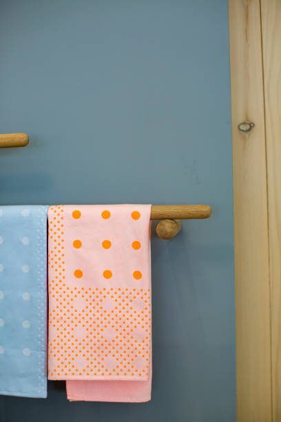 Two small decorative towels hanging on a towel rack