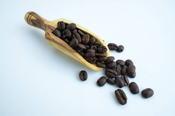 istock Coffee bean on natural wood table with great texture and ambiance background 1182914206