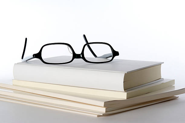 istock Stacked white blank books with glasses on white background 118291533