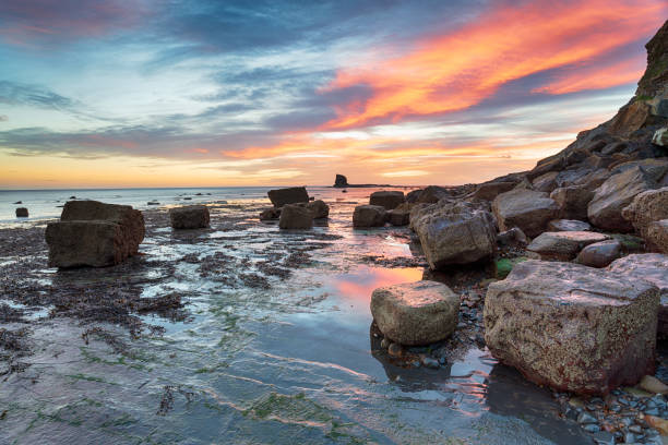 Stunning sunrise on the beach at Saltwick Bay on the North Yorkshire coast btween Whitby and Robin Hoods Bay