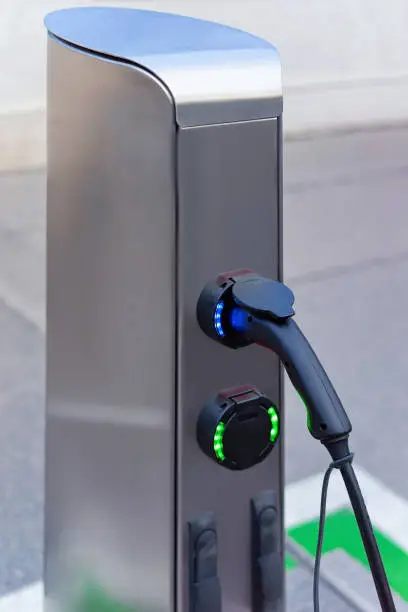 Electric Car Charging station in Vienna in Austria. Battery hybrid vehicle eco charger. Future energy power. Green technology. Transport plug. Fuel recharge. Clean ecology concept. Modern supply