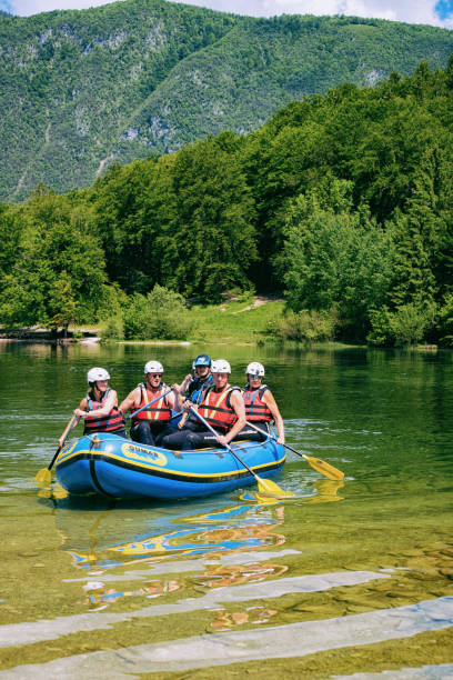 scenery of man canoeing on bohinj lake in slovenia - julian alps lake bohinj lake bohinj imagens e fotografias de stock