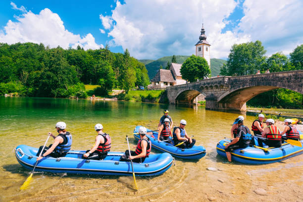 scenery of men canoeing on bohinj lake in slovenia - julian alps lake bohinj lake bohinj imagens e fotografias de stock