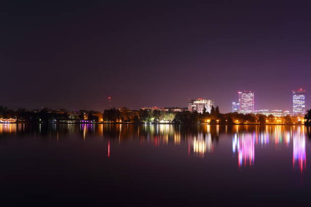 istock Night picture of skyline reflected in lake 1182917453