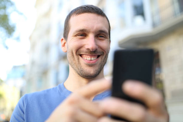 istock Happy adult man browsing mobile phone content 1182917968