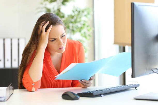 istock Worried busnesswoman discovering mistake on document 1182918986