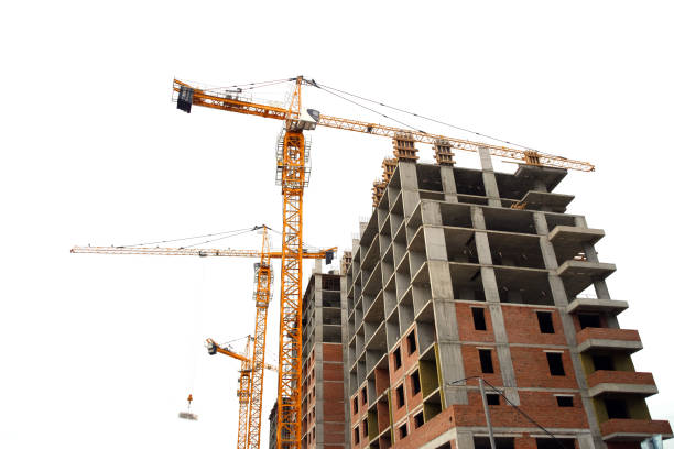 istock Construction site, building a new house, cranes, white sky background 1182919965