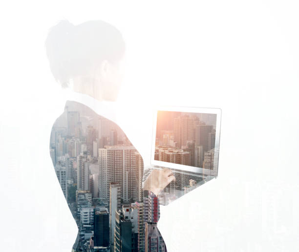istock Multiple exposure of businesswoman using laptop 1182920038