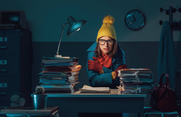 istock Woman freezing in the office 1182921711