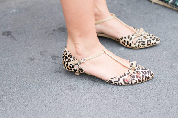istock Model wears low pair of leopard shoes 1182922738