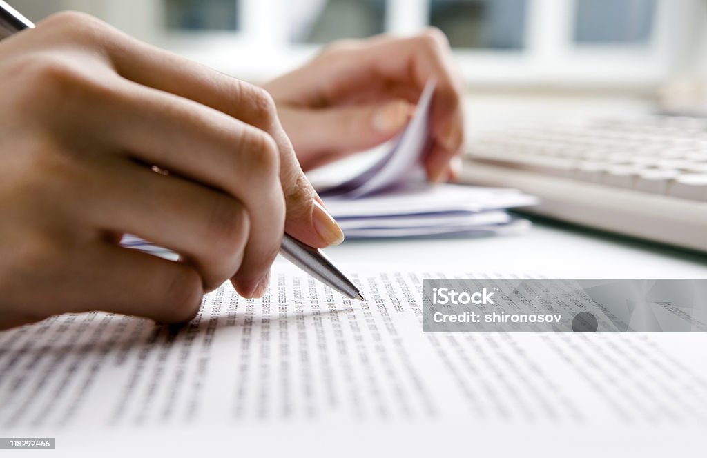 Close-up of human hands doing paperwork  Writing - Activity Stock Photo