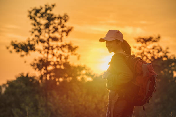 istock Hipster young Traveler with backpack enjoying sunset at the mountain. 1182926734