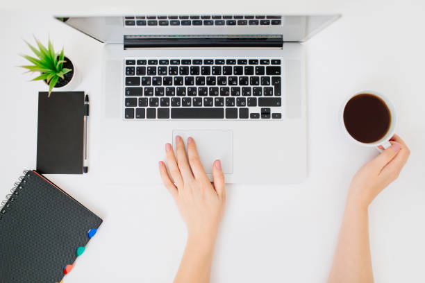 istock Flatlay with female hands and laptop. White desk. 1182929089