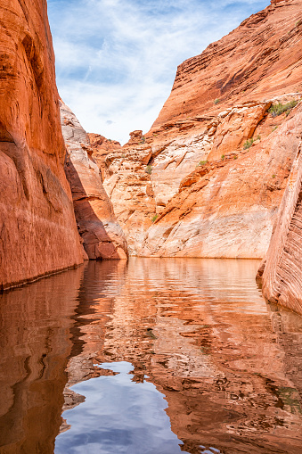 Lake Powell antelope slot canyon with reflection on water surface and rock formations with nobody desert landscape vertical view