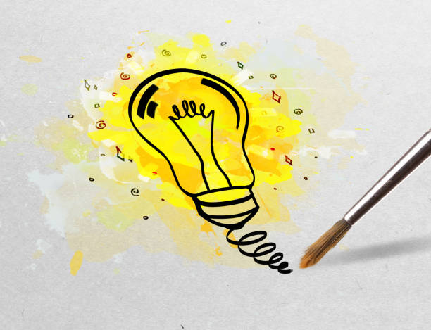 istock Pencil drawing colorful bulb on paper 1182931625