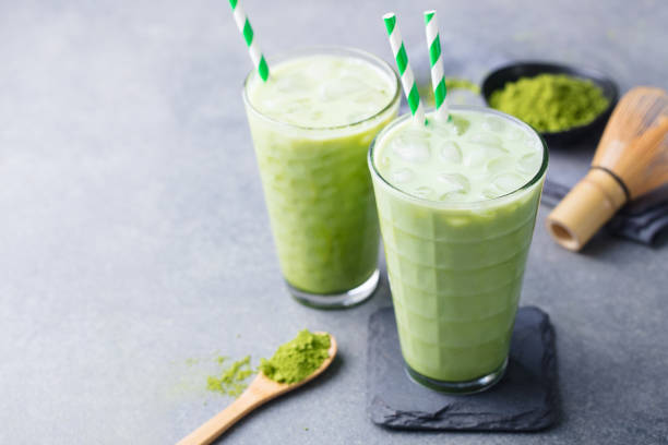 istock Matcha green tea ice latte with matcha powder and bamboo whisk. Copy space. 1182932608