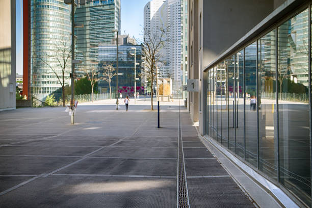 Architectural perspective of urban environment with buildings and pavement along a walkway with shop a urban fixtures in Vienna, Austria.