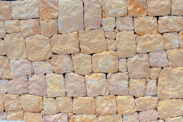 istock Masonry wall of stones with irregular pattern texture background 1182932823
