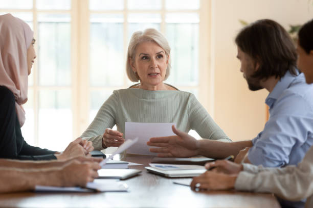 istock Mature company ceo holding document leading corporate group meeting 1182933838