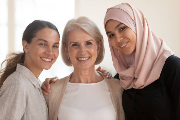 istock Happy beautiful diverse two generation women bonding looking at camera 1182934022