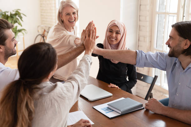 istock Successful multicultural business team people give high five at meeting 1182934032