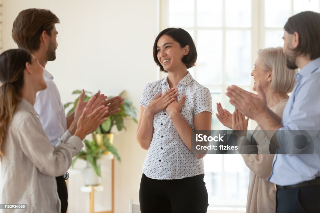 Pleased proud asian young businesswoman get team appreciation support applause Pleased proud asian young businesswoman get multiethnic team appreciation support applause, happy diverse business people group applauding praising korean female worker, employee recognition concept Award Stock Photo