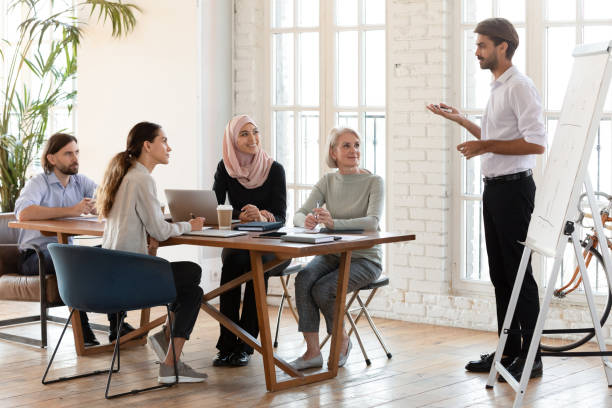 istock Confident businessman trainer give flip chart presentation at corporate training 1182934440