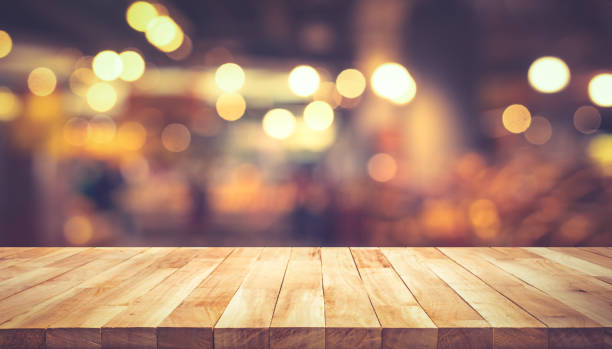 istock Wood texture table top (counter bar) with blur light gold bokeh in cafe,restaurant background 1182934444