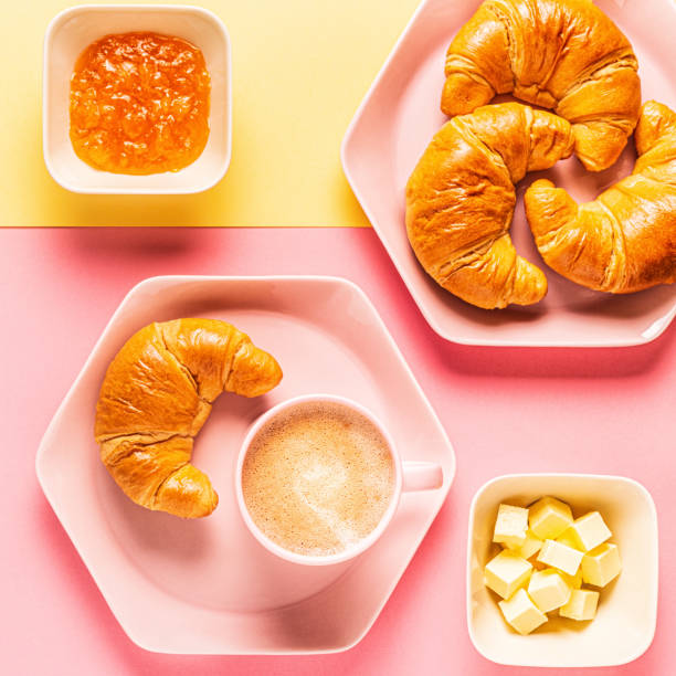 istock Coffee and croissants on a bright trendy background 1182936714