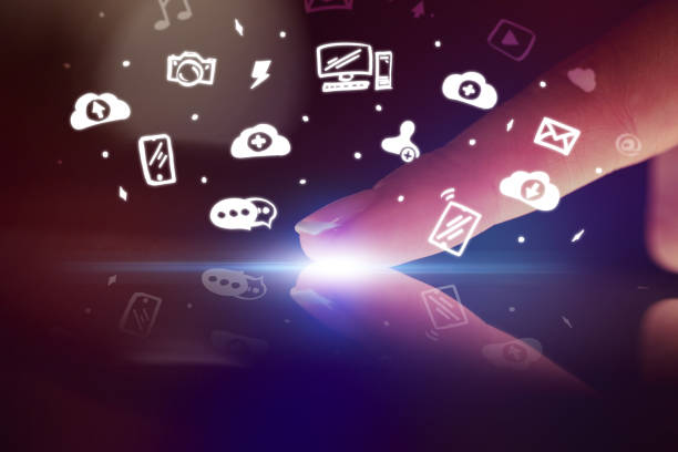 istock Finger touching tablet with white app icons above 1182937862