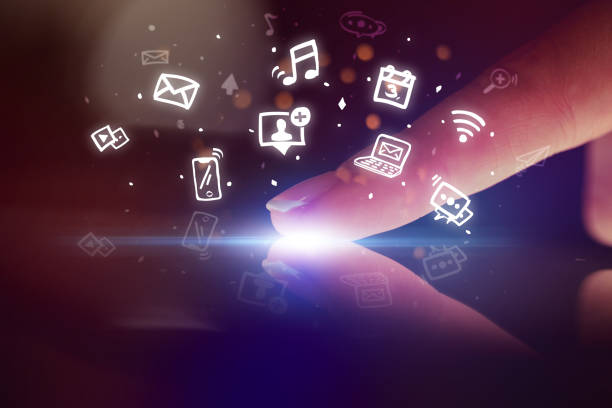 istock Finger touching tablet with hologram app icons above 1182937908