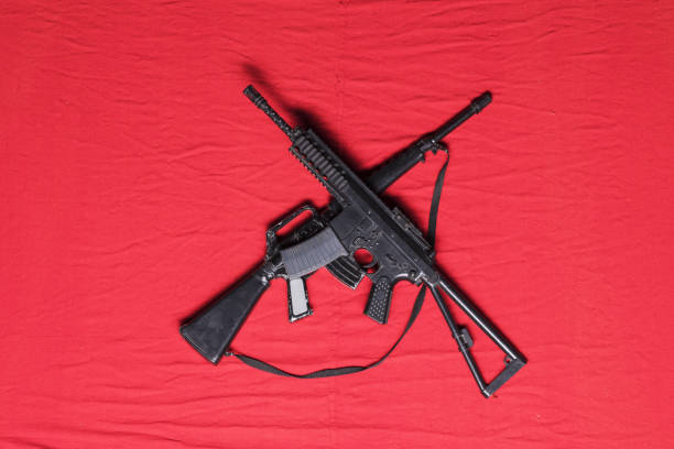 istock Kalashnikov assault rifle AK-47 on a red background 1182938188