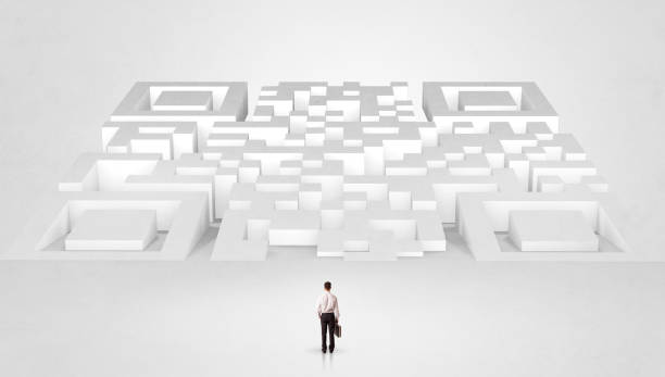 istock Small man standing in front of a huge maze 1182938333