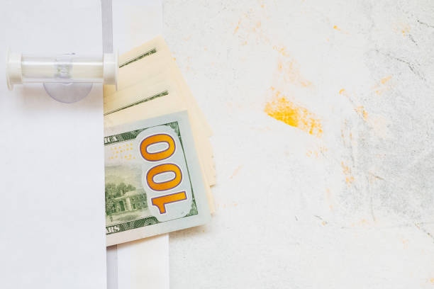 istock Restaurant bill with dollar bills tips on a plate and receipt 1182939689