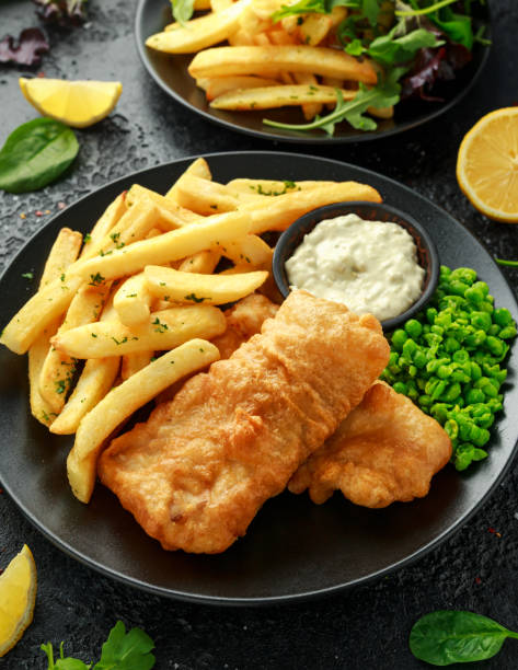 istock British Traditional Fish and chips with mashed peas, tartar sauce and cold beer. 1182940256