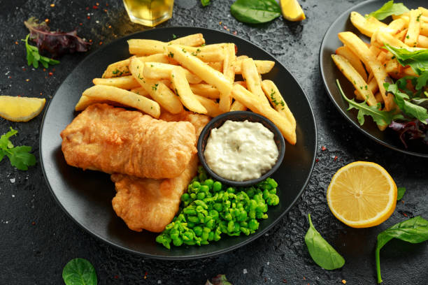 istock British Traditional Fish and chips with mashed peas, tartar sauce and cold beer. 1182940287